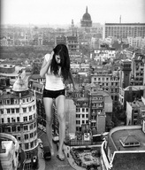 giantess crush collage city monochrome black_hair barefoot legs shorts london looking_down vintage white_top