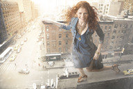 giantess collage city long_hair skirt high_heels high_angle smiling red_hair curly_hair necklace denim_jacket