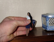 collage black_hair asian hand shrunken_woman captured between_fingers