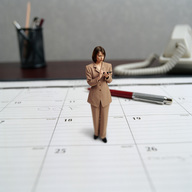 collage clothed brunette short_hair shrunken_woman business_woman table_top cell_phone mobile_phone