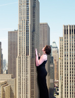giantess collage city black_hair clothed short_hair skyscraper looking_up leaning_against_building