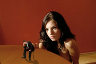 collage brunette shrunken_men sitting suit tabletop looking_at_tiny