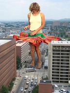 giantess collage city blonde barefoot traffic smiling legs looking_down curly_hair white_top snazzy_skirt