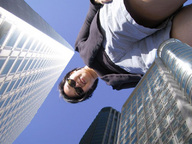 giantess collage city black_hair clothed smiling sunglasses sky sunny point_of_view looking_at_viewer