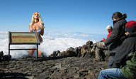 giantess landscape blonde large_breasts long_hair cleavage bra underwear mountains clouds sky touching looking_at_viewer