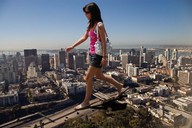 giantess collage city clothed brunette unknown_artist walking sunglasses highway vehicles flip_flops source_needed