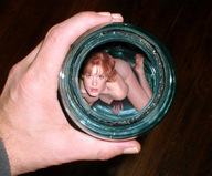 collage nude handheld red_hair hand shrunken_woman entrapment captured jar looking_at_viewer
