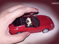 giantess angel finger shrunken_men hand shrunken_man pink_nails grabbing naked_male toy_car ferrari red_toy_car