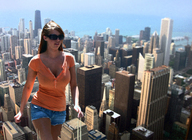 giantess collage city buildings brunette shorts walking sunglasses sky sunny orange_top