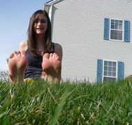 giantess barefoot brunette shrunken_men sitting grass houses outdoors point_of_view looking_at_viewer