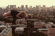 giantess collage city sleeping blonde buildings lying_down unknown_artist rooftop_view crane
