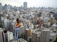 giantess collage city clothed brunette unknown_artist skyscraper streets above_view behind_view downward_angle
