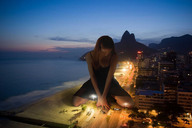 giantess collage city beach ocean buildings unknown_artist hand shrunken_people sand highway night lights kneeling_down crushed_car looking_at_tiny