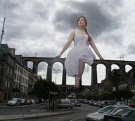 giantess collage bridge barefoot cars buildings red_hair unknown_artist sitting clouds sky white_dress