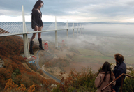 breasts giantess collage landscape mega black_hair bridge clothed cleavage high_heels boots looking_down people clouds sky construction fog mila_kunis accasbel mist milau