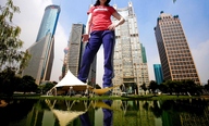 giantess collage city clothed water unknown_artist skyscraper sneakers sky sweat_pants tents upward_anble