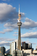 giantess collage city swimsuit buildings climbing brunette boots unknown_artist tower skyscrapers clouds sky looking_at_viewer cn_tower