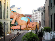 giantess collage city blonde cleavage wonderslug lying_down hand streets looking_at_viewer between_buildings