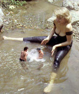 gentle collage blonde barefoot cleavage shrunken_men teasing river outdoors small_sir