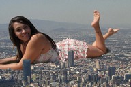 collage city mega barefoot buildings brunette smiling lying_down unknown_artist skyscraper looking_at_viewer
