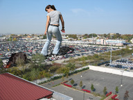 giantess collage destruction clothed jeans brunette wonderslug fire smoke parking_lot vehicle_crush behind_view holding_vehicle
