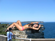 giantess collage black_hair long_hair ocean high_heels wonderslug lying_down legs men looking_at_viewer olivia_munn cliff filming