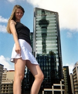 giantess collage city clothed skirt low_angle looking_down skyscraper clouds sky looking_at_viewer
