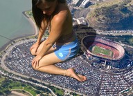 giantess collage clothed barefoot soles brunette stadium unknown_artist kneeling vehicles parking_lot vehicle_crush water_front sports_stadium downward_angle