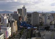 giantess collage city clothed buildings jeans sitting streets vehicles sneakers holding_vehicle