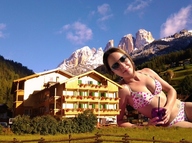 giantess collage swimsuit cleavage buildings brunette unknown_artist grass sunglasses mountains outdoors fence looking_at_viewer mountain_resort