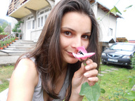 collage handheld brunette brown_eyes shrunken_men shrunken_man flower outdoors looking_at_viewer
