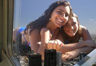 giantess collage city mega blonde swimsuit handheld brunette smiling giantesses flying curly_hair earrings helicopter_point_of_view looking_at_viewer