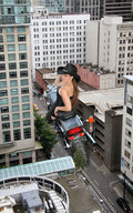 giantess collage city jr streets motorcycle looking_at_viewer between_buildings rooftop cowboy_hat rooftop_view downward_angle