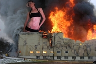 giantess collage destruction buildings unknown_artist fire hat looking_at_viewer baseball_cap navel_ring