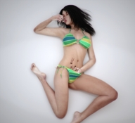 black_hair long_hair swimsuit handheld barefoot lying_down shrunken_people closed_eyes panty_entrapment imminent_vore digital_render flagg3d leg_in_mouth