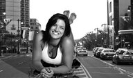 giantess collage city monochrome black_hair cleavage buildings smiling lying_down vehicles looking_at_viewer gina_carano cracked_pavement