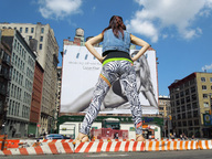 giantess collage city black_hair high_heels pants vehicles sky hands_on_hips billboard calvin_klein jeans_vest barricades