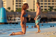 collage swimsuit clothed beach barefoot mini_giantess kneeling standing lowerrider looking_at_tiny swim_trunks