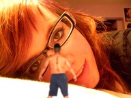 gentle collage long_hair clothed glasses smiling red_hair shorts shrunken_man looking_at_tiny