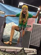 giantess blonde long_hair sandals shorts photograph toe_ring shirt looking_at_viewer fake_city convention silly jena_sims