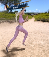 gentle giantess blonde long_hair clothed beach sandals belly airplane running sand ponytails manicure trees hills biplane boardwalk digital_render crop_top pink_pants