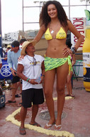 bikini gentle collage long_hair clothed bra brunette smiling unknown_artist sandals amazon standing looking_up outdoors flip_flops nail_polish looking_at_viewer bracelet semi_nude source_needed cowboy_hat sarong bare_legs dogtags corona bare_midriff bare_thighs