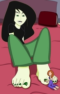 drawing feet black_hair color long_hair clothed toes barefoot bed green_eyes brunette kim_possible shego shrunken_woman pedicure blanket pillows green_skin looking_at_tiny dbzfan13 painting-her-nails kigo