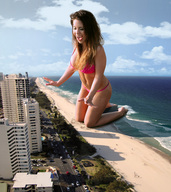 giantess collage swimsuit beach ocean buildings brunette smiling wonderslug kneeling hand giantess_katelyn waves sand vehicles sky resort navel_ring