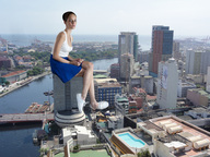 breasts giantess collage city mega skirt water short_hair river boats sneakers wife_beater top looking_at_viewer legs_crossed sitting_on_building ser-gts
