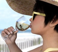 black_hair beach dress short_hair glass shrunken_woman sunglasses drinking hat boomgts looking_at_tiny digital_render