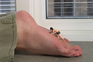 collage feet barefoot soles climbing lying_down shrunken_man indoors on_sole digital_render starkadhr