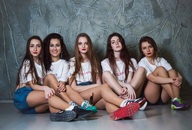 collage black_hair long_hair brunette sitting shorts shrunken_woman lipstick sneakers shirt wavy_hair legs_crossed