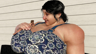 black_hair handheld bra huge_breasts smiling sitting medium_length_hair shrunken_man looking_down digital_render on_breasts