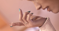 micro handheld looking_down nail_polish hanging_on blue_nails on_finger digital_render contact_lens